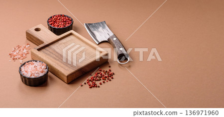Empty wooden cutting board with a knife for food preparation. An empty wooden cutting board Empty wooden cutting board with a knife for food preparation. An empty wooden cutting board 136971960