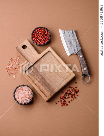 Empty wooden cutting board with a knife for food preparation. An empty wooden cutting board Empty wooden cutting board with a knife for food preparation. An empty wooden cutting board 136971962