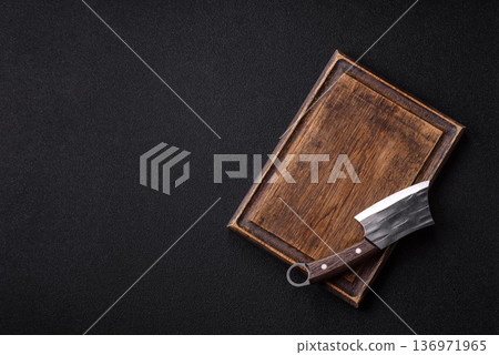 Empty wooden cutting board with a knife for food preparation. An empty wooden cutting board 136971965