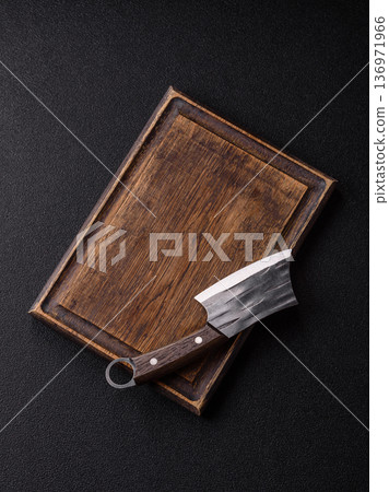 Empty wooden cutting board with a knife for food preparation. An empty wooden cutting board Empty wooden cutting board with a knife for food preparation. An empty wooden cutting board 136971966