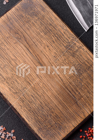 Empty wooden cutting board with a knife for food preparation. An empty wooden cutting board Empty wooden cutting board with a knife for food preparation. An empty wooden cutting board 136971971