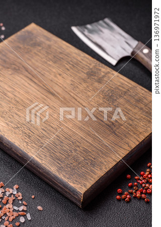 Empty wooden cutting board with a knife for food preparation. An empty wooden cutting board Empty wooden cutting board with a knife for food preparation. An empty wooden cutting board 136971972