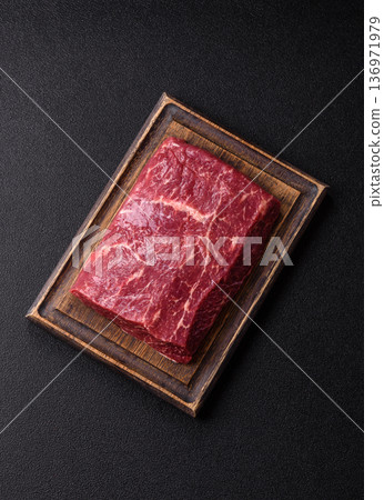 A piece of raw beef, a tenderloin for grilling or barbecue. Raw beef A piece of raw beef, a tenderloin for grilling or barbecue. Raw beef 136971979