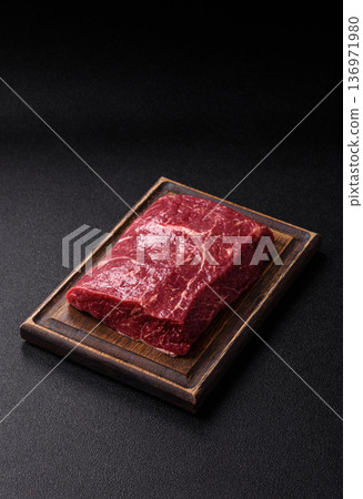 A piece of raw beef, a tenderloin for grilling or barbecue. Raw beef A piece of raw beef, a tenderloin for grilling or barbecue. Raw beef 136971980