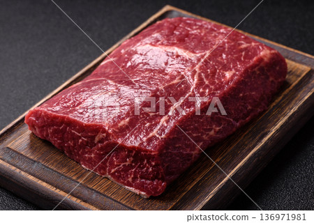 A piece of raw beef, a tenderloin for grilling or barbecue. Raw beef 136971981