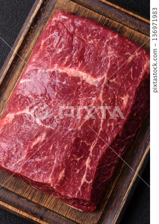 A piece of raw beef, a tenderloin for grilling or barbecue. Raw beef A piece of raw beef, a tenderloin for grilling or barbecue. Raw beef 136971983