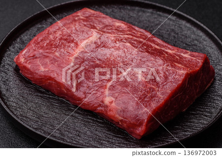 A piece of raw beef, a tenderloin for grilling or barbecue. Raw beef 136972003