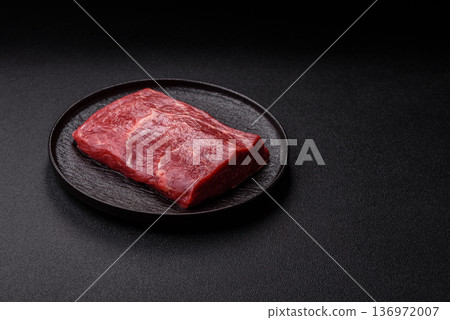 A piece of raw beef, a tenderloin for grilling or barbecue. Raw beef 136972007