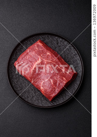 A piece of raw beef, a tenderloin for grilling or barbecue. Raw beef 136972009