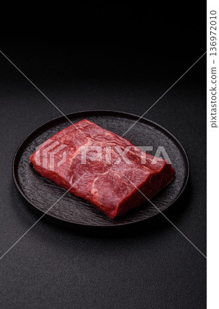 A piece of raw beef, a tenderloin for grilling or barbecue. Raw beef 136972010