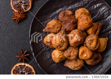 Dried fig are a sweet, healthy fruit for vegans and vegetarians. Dried fig as a food background Dried fig are a sweet, healthy fruit for vegans and vegetarians. Dried fig as a food background 136972016