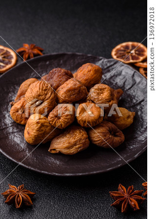 Dried fig are a sweet, healthy fruit for vegans and vegetarians. Dried fig as a food background 136972018