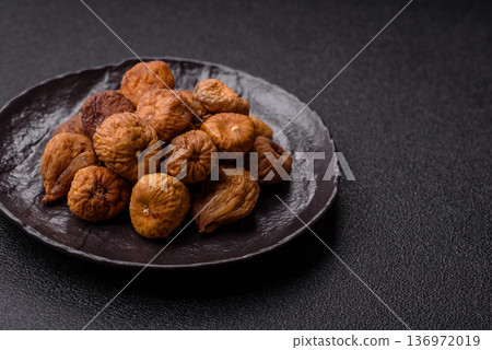 Dried fig are a sweet, healthy fruit for vegans and vegetarians. Dried fig as a food background Dried fig are a sweet, healthy fruit for vegans and vegetarians. Dried fig as a food background 136972019