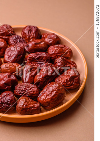 Red dried dates, the Chinese sweet fruit jujube, as a healthy food. Red dates, jujube Red dried dates, the Chinese sweet fruit jujube, as a healthy food. Red dates, jujube 136972072