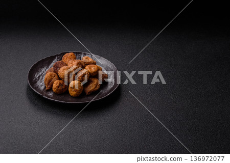 Dried fig are a sweet, healthy fruit for vegans and vegetarians. Dried fig as a food background Dried fig are a sweet, healthy fruit for vegans and vegetarians. Dried fig as a food background 136972077