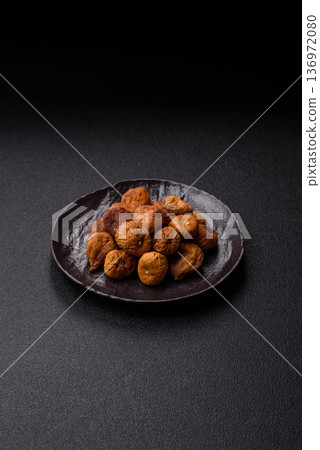 Dried fig are a sweet, healthy fruit for vegans and vegetarians. Dried fig as a food background Dried fig are a sweet, healthy fruit for vegans and vegetarians. Dried fig as a food background 136972080