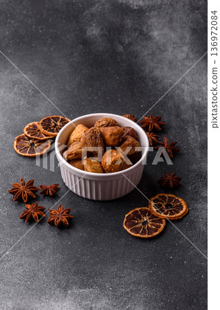 Dried fig are a sweet, healthy fruit for vegans and vegetarians. Dried fig as a food background Dried fig are a sweet, healthy fruit for vegans and vegetarians. Dried fig as a food background 136972084