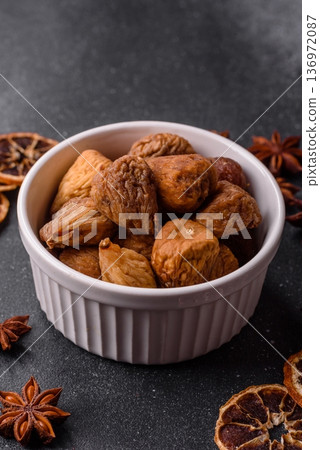 Dried fig are a sweet, healthy fruit for vegans and vegetarians. Dried fig as a food background 136972087