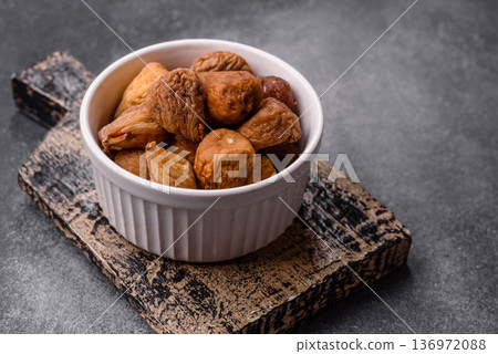 Dried fig are a sweet, healthy fruit for vegans and vegetarians. Dried fig as a food background 136972088