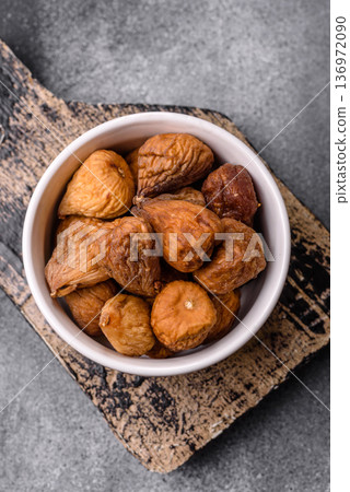 Dried fig are a sweet, healthy fruit for vegans and vegetarians. Dried fig as a food background 136972090