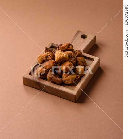 Dried fig are a sweet, healthy fruit for vegans and vegetarians. Dried fig as a food background Dried fig are a sweet, healthy fruit for vegans and vegetarians. Dried fig as a food background 136972099
