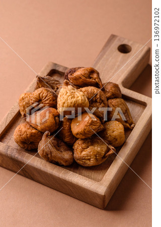 Dried fig are a sweet, healthy fruit for vegans and vegetarians. Dried fig as a food background Dried fig are a sweet, healthy fruit for vegans and vegetarians. Dried fig as a food background 136972102