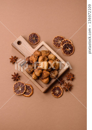 Dried fig are a sweet, healthy fruit for vegans and vegetarians. Dried fig as a food background Dried fig are a sweet, healthy fruit for vegans and vegetarians. Dried fig as a food background 136972109
