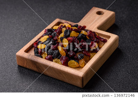 Dried cranberries, yellow and black sweet raisins as ingredients for a breakfast. Raisins and cranberries 136972146