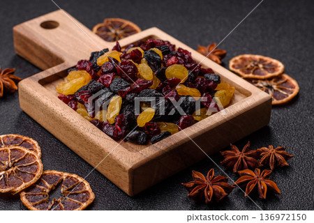 Dried cranberries, yellow and black sweet raisins as ingredients for a breakfast. Raisins and cranberries 136972150