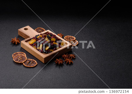 Dried cranberries, yellow and black sweet raisins as ingredients for a breakfast. Raisins and cranberries Dried cranberries, yellow and black sweet raisins as ingredients for a breakfast. Raisins and cranberries 136972154