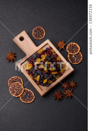 Dried cranberries, yellow and black sweet raisins as ingredients for a breakfast. Raisins and cranberries 136972156