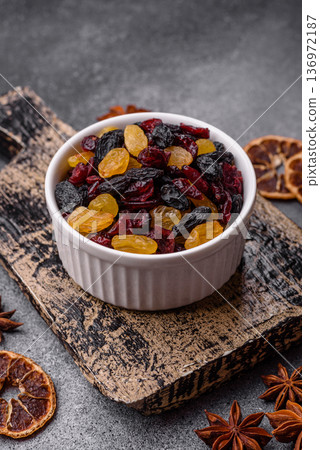 Dried cranberries, yellow and black sweet raisins as ingredients for a breakfast. Raisins and cranberries 136972187