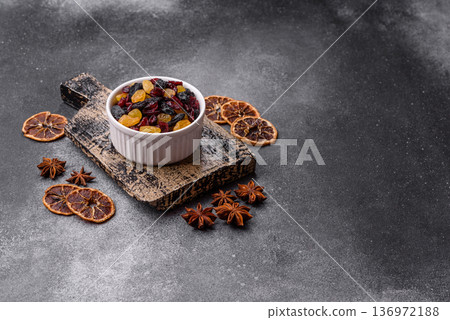 Dried cranberries, yellow and black sweet raisins as ingredients for a breakfast. Raisins and cranberries 136972188