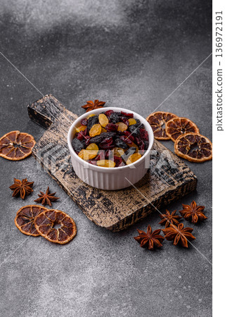 Dried cranberries, yellow and black sweet raisins as ingredients for a breakfast. Raisins and cranberries Dried cranberries, yellow and black sweet raisins as ingredients for a breakfast. Raisins and cranberries 136972191