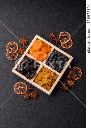 A variety of dried fruits, apricots, prunes, cranberries, raisins, figs, and dates for a healthy breakfast. A dried fruit mix A variety of dried fruits, apricots, prunes, cranberries, raisins, figs, and dates for a healthy breakfast. A dried fruit mix 136972194