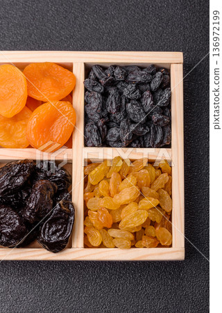 A variety of dried fruits, apricots, prunes, cranberries, raisins, figs, and dates for a healthy breakfast. A dried fruit mix A variety of dried fruits, apricots, prunes, cranberries, raisins, figs, and dates for a healthy breakfast. A dried fruit mix 136972199