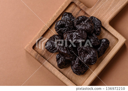 Sweet dried plums or prunes, organic dehydrated fruit for dietary nutrition. Prunes or dried plums 136972210