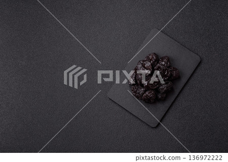 Sweet dried plums or prunes, organic dehydrated fruit for dietary nutrition. Prunes or dried plums 136972222