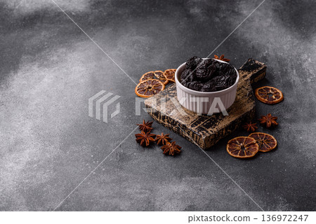 Sweet dried plums or prunes, organic dehydrated fruit for dietary nutrition. Prunes or dried plums 136972247