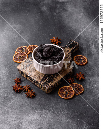 Sweet dried plums or prunes, organic dehydrated fruit for dietary nutrition. Prunes or dried plums 136972253