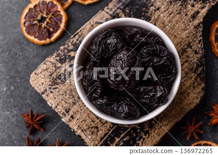 Sweet dried plums or prunes, organic dehydrated fruit for dietary nutrition. Prunes or dried plums 136972265