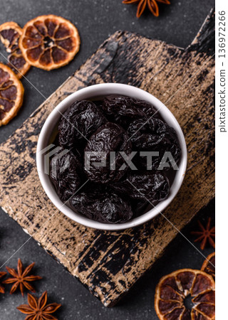 Sweet dried plums or prunes, organic dehydrated fruit for dietary nutrition. Prunes or dried plums 136972266