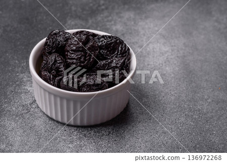 Sweet dried plums or prunes, organic dehydrated fruit for dietary nutrition. Prunes or dried plums Sweet dried plums or prunes, organic dehydrated fruit for dietary nutrition. Prunes or dried plums 136972268