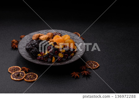 A variety of dried fruits, apricots, prunes, cranberries, raisins, figs, and dates for a healthy breakfast. A dried fruit mix A variety of dried fruits, apricots, prunes, cranberries, raisins, figs, and dates for a healthy breakfast. A dried fruit mix 136972288