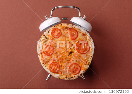 Vintage alarm clock on brown surface as a conceptual background for deadlines for tasks 136972303