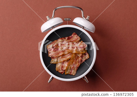 Vintage alarm clock on brown surface as a conceptual background for deadlines for tasks 136972305