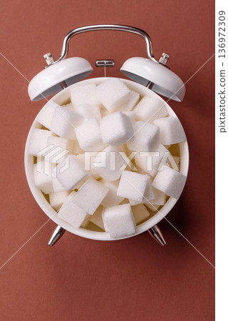 Vintage alarm clock on brown surface as a conceptual background for deadlines for tasks 136972309