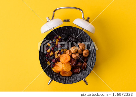 A variety of dried fruits, apricots, prunes, cranberries, raisins, figs. A dried fruit mix A variety of dried fruits, apricots, prunes, cranberries, raisins, figs. A dried fruit mix 136972328
