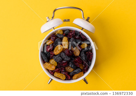 Dried cranberries, yellow and black sweet raisins as ingredients. Raisins and cranberries 136972330