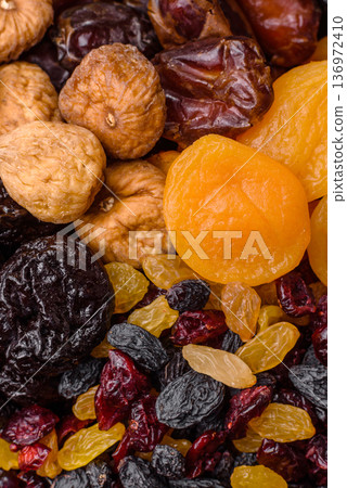 A variety of dried fruits, apricots, prunes, cranberries, raisins, figs, and dates for a healthy breakfast. A dried fruit mix A variety of dried fruits, apricots, prunes, cranberries, raisins, figs, and dates for a healthy breakfast. A dried fruit mix 136972410